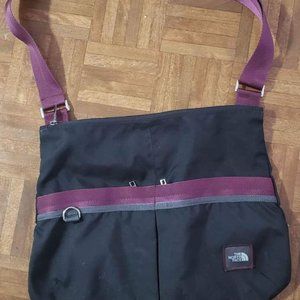 Black and red The North Face sling crossbody bag